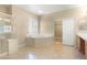 Primary bathroom with double sink vanity, shower, and separate soaking tub at 10013 Scenic Walk Ave, Las Vegas, NV 89149