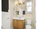 Functional bathroom with a single sink vanity, toilet, and a well-lit mirror providing a practical and neat space at 10013 Scenic Walk Ave, Las Vegas, NV 89149