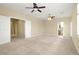 Spacious primary bedroom offering plush carpet, neutral walls, ceiling fans, and ensuite bath, creating a tranquil retreat at 10013 Scenic Walk Ave, Las Vegas, NV 89149
