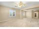 Open bonus room featuring neutral carpeting and natural light from the windows at 10013 Scenic Walk Ave, Las Vegas, NV 89149