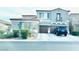 Charming two-story home features a two-car garage, and blue shutters, creating a welcoming curb appeal at 10013 Scenic Walk Ave, Las Vegas, NV 89149