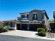 Charming two-story home featuring a tile roof and a three-car garage at 10013 Scenic Walk Ave, Las Vegas, NV 89149