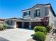 Stunning two-story home featuring a three-car garage and lush landscaping with mature bushes at 10013 Scenic Walk Ave, Las Vegas, NV 89149