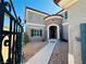 Stunning two-story home featuring a stone turret entry and manicured landscaping, showcasing curb appeal at 10013 Scenic Walk Ave, Las Vegas, NV 89149