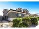 Inviting two-story home featuring a well-maintained lawn, beautiful landscaping, and a security system at 10013 Scenic Walk Ave, Las Vegas, NV 89149