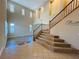Elegant foyer with a staircase, high ceilings, shuttered windows, and hardwood flooring visible in the adjacent room at 10013 Scenic Walk Ave, Las Vegas, NV 89149