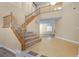 Spacious foyer with tiled floors and a staircase with wooden railing at 10013 Scenic Walk Ave, Las Vegas, NV 89149