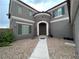 Inviting two-story home with a unique stone turret entrance and modern architectural design at 10013 Scenic Walk Ave, Las Vegas, NV 89149