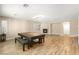 Spacious game room with wood floors, a fireplace, and bright natural light from the large window at 10013 Scenic Walk Ave, Las Vegas, NV 89149