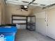 Organized garage space with shelving and storage bins, enhanced by a ceiling fan for ventilation at 10013 Scenic Walk Ave, Las Vegas, NV 89149