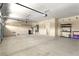 Spacious garage with plenty of room for storage, equipped with shelving and overhead door at 10013 Scenic Walk Ave, Las Vegas, NV 89149