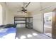 A two car garage features practical storage solutions with installed shelves and ample workspace at 10013 Scenic Walk Ave, Las Vegas, NV 89149