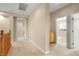Hallway with neutral paint, plush carpeting, and doors leading to various rooms providing a bright and welcoming transition between spaces at 10013 Scenic Walk Ave, Las Vegas, NV 89149