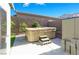 Backyard with a hot tub, concrete patio, and privacy fence at 10013 Scenic Walk Ave, Las Vegas, NV 89149