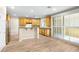 Open kitchen with stainless appliances, wood cabinets and flooring, and sliding doors at 10013 Scenic Walk Ave, Las Vegas, NV 89149
