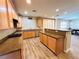Bright kitchen featuring wooden cabinets, stainless steel appliances, and granite countertops with hardwood flooring at 10013 Scenic Walk Ave, Las Vegas, NV 89149