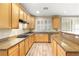 Well-lit kitchen featuring light wood cabinets, stainless steel appliances, and sleek countertops at 10013 Scenic Walk Ave, Las Vegas, NV 89149
