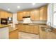 Traditional kitchen with wood cabinets, stone countertops, and modern appliances at 10013 Scenic Walk Ave, Las Vegas, NV 89149