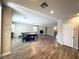Open-concept living area with a fireplace, hardwood floors, and a billiards table for entertainment at 10013 Scenic Walk Ave, Las Vegas, NV 89149