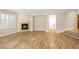Cozy living room with hardwood floors, a tile fireplace, and shuttered windows for ample light control at 10013 Scenic Walk Ave, Las Vegas, NV 89149