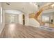 Spacious living room featuring hardwood floors, abundant natural light, and elegant chandelier at 10013 Scenic Walk Ave, Las Vegas, NV 89149