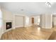 Spacious living room featuring a fireplace, wood floors, and neutral paint colors at 10013 Scenic Walk Ave, Las Vegas, NV 89149