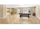 Open-concept living space with a table and bench, wood floors, and natural light at 10013 Scenic Walk Ave, Las Vegas, NV 89149