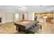 Open living space featuring wood floors, a table, and access to the kitchen at 10013 Scenic Walk Ave, Las Vegas, NV 89149