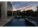 Serene backyard pool at dusk with in-pool loungers at 10756 Steel Ridge Ct, Las Vegas, NV 89135