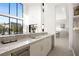 Open concept wet bar features sleek countertops, a beverage fridge, and seamless access to the outdoors at 10756 Steel Ridge Ct, Las Vegas, NV 89135