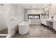 Spacious bathroom featuring a freestanding tub, a walk-in shower, and marble accents at 10756 Steel Ridge Ct, Las Vegas, NV 89135