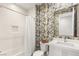 Charming bathroom with tub/shower combo and fun wallpaper at 10756 Steel Ridge Ct, Las Vegas, NV 89135