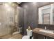 Modern bathroom featuring tiled walls, glass shower, floating vanity, and contemporary fixtures at 10756 Steel Ridge Ct, Las Vegas, NV 89135