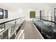 Upstairs hallway boasting modern glass railings and bright lighting at 10756 Steel Ridge Ct, Las Vegas, NV 89135