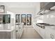 Bright, modern kitchen featuring white cabinetry, stainless steel appliances, and outdoor access at 10756 Steel Ridge Ct, Las Vegas, NV 89135