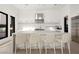 Contemporary kitchen with a spacious island, barstool seating, and stainless steel appliances at 10756 Steel Ridge Ct, Las Vegas, NV 89135