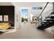 Bright, open living area with soaring ceilings, modern staircase, and stylish furnishings at 10756 Steel Ridge Ct, Las Vegas, NV 89135