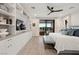 Bright and airy main bedroom with a king bed, ceiling fan, and private balcony access at 10756 Steel Ridge Ct, Las Vegas, NV 89135