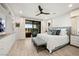 Bright and airy main bedroom with a king bed, ceiling fan, and private balcony access at 10756 Steel Ridge Ct, Las Vegas, NV 89135