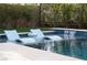 Relaxing pool with in-pool loungers and a waterfall feature at 10756 Steel Ridge Ct, Las Vegas, NV 89135