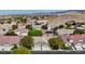 Aerial view of a suburban neighborhood with desert landscaping and a house with solar panels at 10980 Ampus Pl, Las Vegas, NV 89141