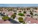 View of a well-maintained suburban neighborhood with mature trees and houses with terracotta roofs at 10980 Ampus Pl, Las Vegas, NV 89141