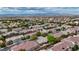Expansive aerial view of a residential neighborhood with mountain backdrop and neatly arranged single-Gathering homes at 10980 Ampus Pl, Las Vegas, NV 89141