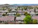 View of a house within a suburban neighborhood from above, showing the backyard deck and landscaping at 10980 Ampus Pl, Las Vegas, NV 89141
