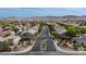 An elevated view of a well maintained neighborhood featuring tree-lined streets and manicured landscaping at 10980 Ampus Pl, Las Vegas, NV 89141