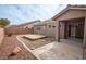 View of the house from the back yard, showing a deck area, low maintenance landscaping, and stucco walls at 10980 Ampus Pl, Las Vegas, NV 89141