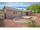 A landscaped backyard is complete with a gravel bed, wooden deck, and covered patio at 10980 Ampus Pl, Las Vegas, NV 89141