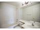 Bright bathroom featuring a shower-tub combination and a large mirror at 10980 Ampus Pl, Las Vegas, NV 89141