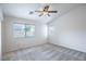 Bedroom with ceiling fan and a sunny view from the large window at 10980 Ampus Pl, Las Vegas, NV 89141