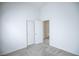 This bedroom features an open door, closet doors and neutral paint and carpet at 10980 Ampus Pl, Las Vegas, NV 89141